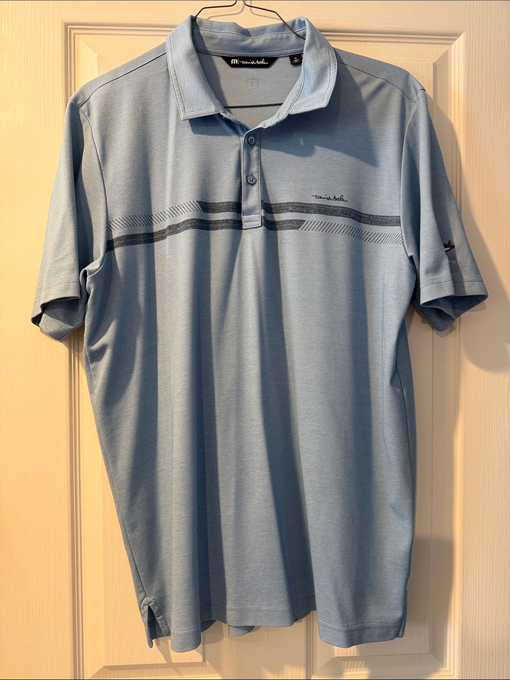 Travis Mathew Light Blue Polo with Horizontal Chest Stripe